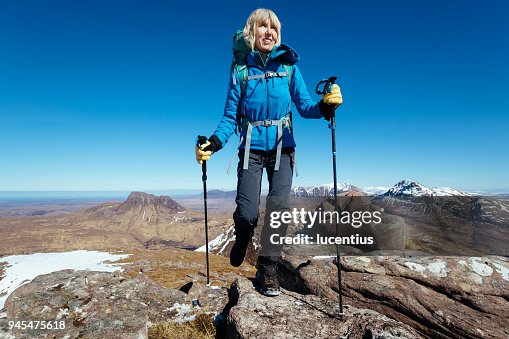 Active senior, Stac Pollaidh background, Scotland Active senior, Stac Pollaidh background, Scotland