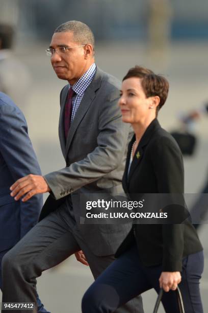 Jamaica's Prime Minister Andrew Holness and his Minister of Foreign Affairs Kamina Johnson-Smith walk upon arrival at the Peruvian Air Force Grupo...