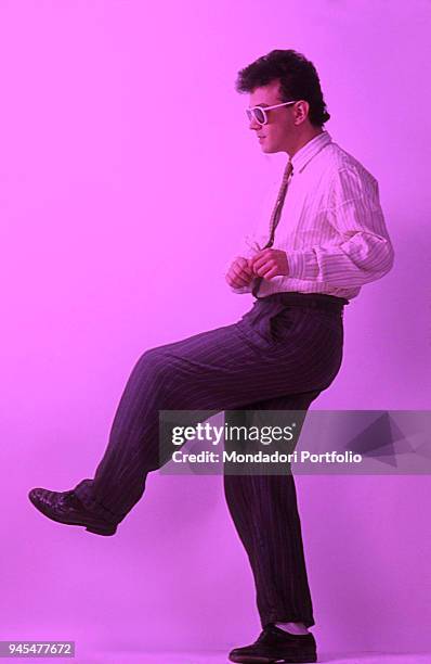 The singer-songwriter Enrico Ruggeri rising one leg. 1985