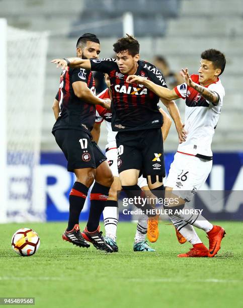 Brazil's Atletico Paranaense player Matheus Rossetto vies for the ball with Argentina's Newell's Old Boys player Hector Fertoli during their Copa...