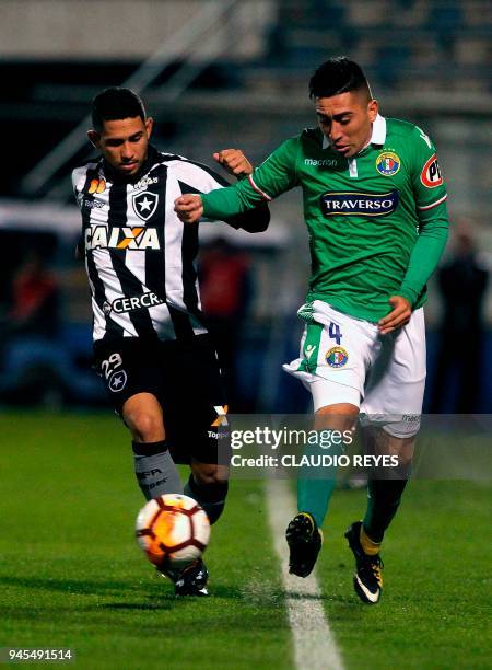 Brazil's Botafogo player Leandro Carvalho vies for the ball with Chile's Audax Italiano player Osvaldo Bosso during their Copa Sudamericana football...