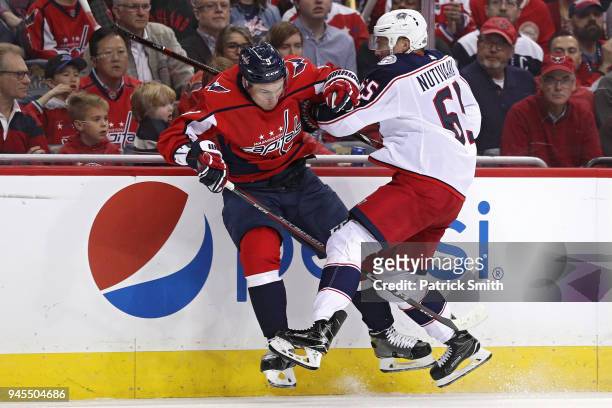 Markus Nutivaara of the Columbus Blue Jackets checks Dmitry Orlov of the Washington Capitals in the first period in Game One of the Eastern...