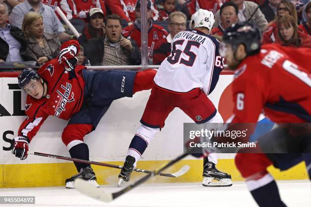 Markus Nutivaara of the Columbus Blue Jackets checks Dmitry Orlov of the Washington Capitals in the first period in Game One of the Eastern...