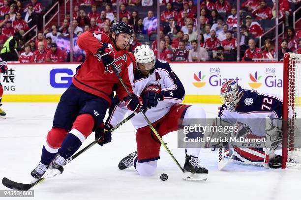 Nicklas Backstrom of the Washington Capitals and Seth Jones of the Columbus Blue Jackets battle for the puck in the first period in Game One of the...