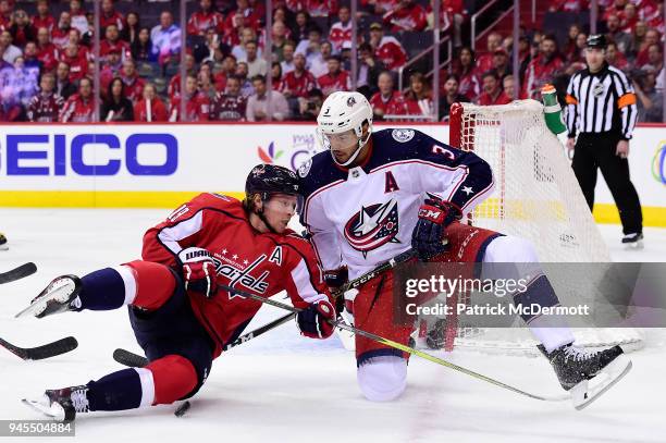 Nicklas Backstrom of the Washington Capitals and Seth Jones of the Columbus Blue Jackets battle for the puck in the first period in Game One of the...