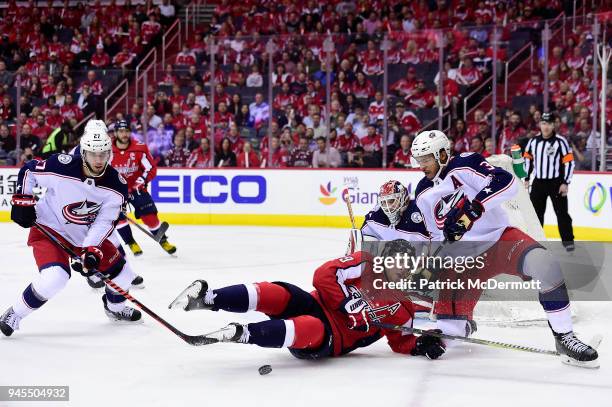 Nicklas Backstrom of the Washington Capitals and Seth Jones of the Columbus Blue Jackets battle for the puck in the first period in Game One of the...