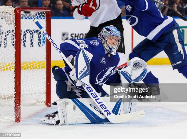 The puck flies by the head of goalie Andrei Vasilevskiy of the Tampa Bay Lightning and hits the post against the New Jersey Devils in Game One of the...