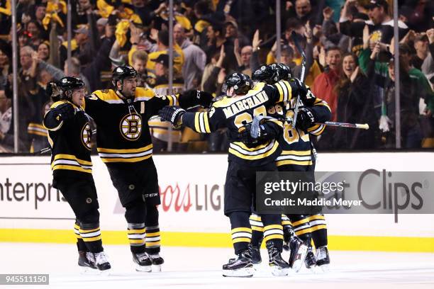 David Pastrnak celebrates with Brad Marchand, Torey Krug and Patrice Bergeron after scoring a goal against the Toronto Maple Leafs during the second...