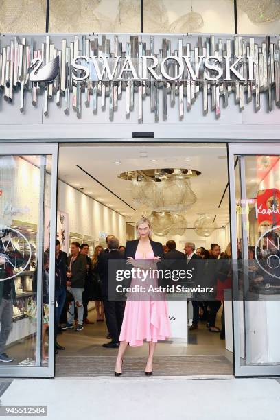 Swarovski brand ambassador, Karlie Kloss cuts the ceremonial ribbon at the brands latest flagship location in New York Citys Times Square in honor of...