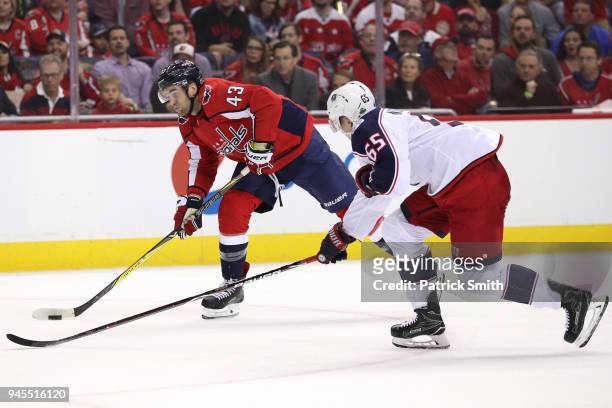 Tom Wilson of the Washington Capitals shoots in front of Markus Nutivaara of the Columbus Blue Jackets in the second period in Game One of the...