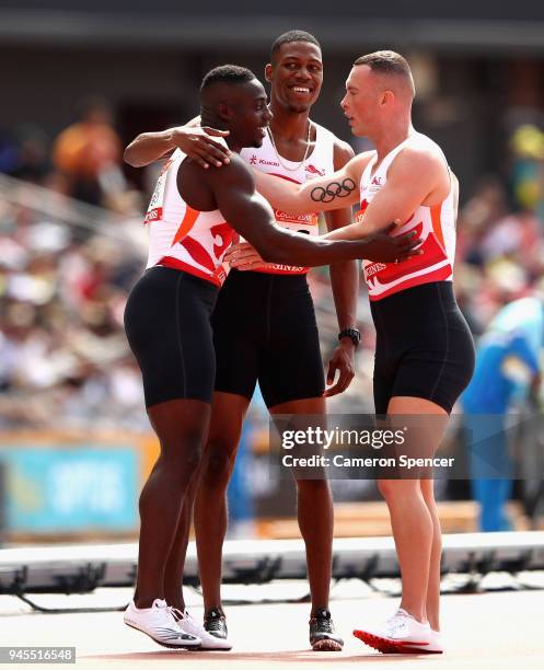 Harry Aikines-Aryeetey of England, Zharnel Hughes of England and Richard Kilty of England celebrate after the Men's 4x100 metres relay heats during...