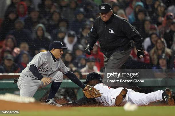 Boston Red Sox Jackie Bradley Jr. Slides safely into third base after stealing from second after New York Yankees catcher Gary Sanchez, not pictured,...