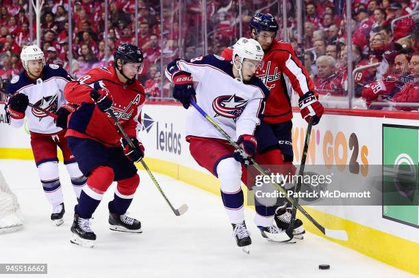 Pierre-Luc Dubois of the Columbus Blue Jackets and Matt Niskanen of the Washington Capitals battle for the puck in the second period in Game One of...