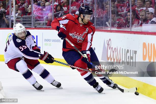 Brooks Orpik of the Washington Capitals and Mark Letestu of the Columbus Blue Jackets battle for the puck in the second period in Game One of the...