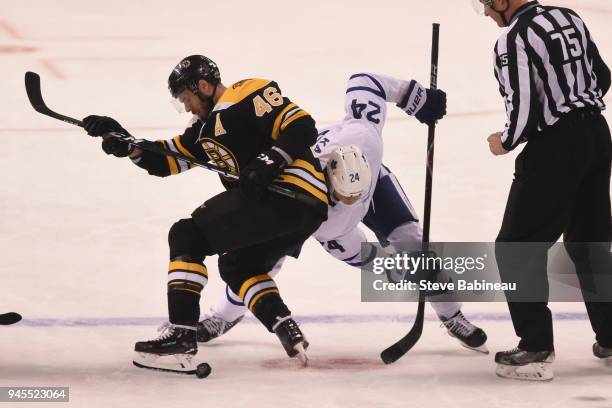 David Krejci of the Boston Bruins fights for the puck against Kasperi Kapanen of the Toronto Maple Leafs during the First Round of the 2018 Stanley...