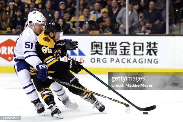 Jake Gardiner of the Toronto Maple Leafs defends Kevan Miller of the Boston Bruins during the third period of Game One of the Eastern Conference...