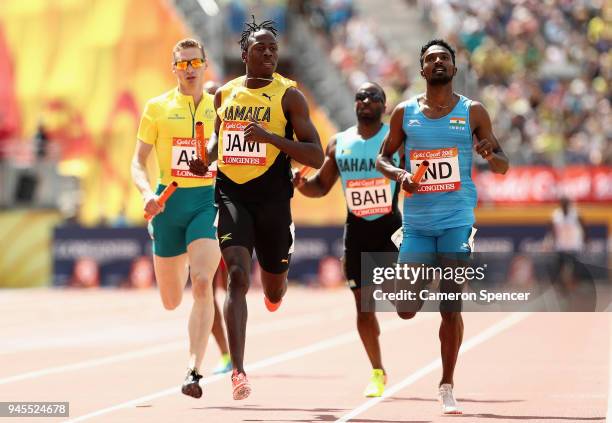 Javon Francis of Jamaica, Arokia Rajiv of India and Steven Solomon of Australia cross the line in the Men's 4x400 metres relay heats during athletic...