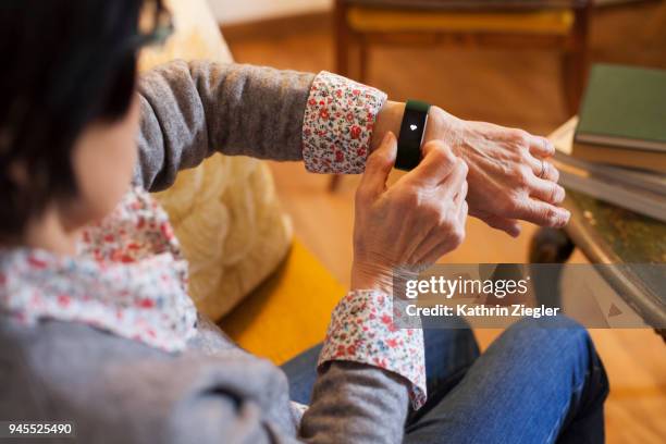 senior woman using smart watch with health app - lazio medical tests stock pictures, royalty-free photos & images