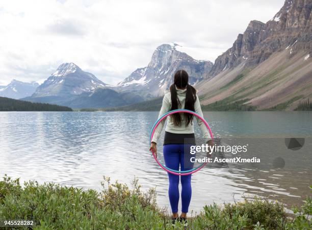 native american woman dances with hoops, in mountains - hooping stock pictures, royalty-free photos & images