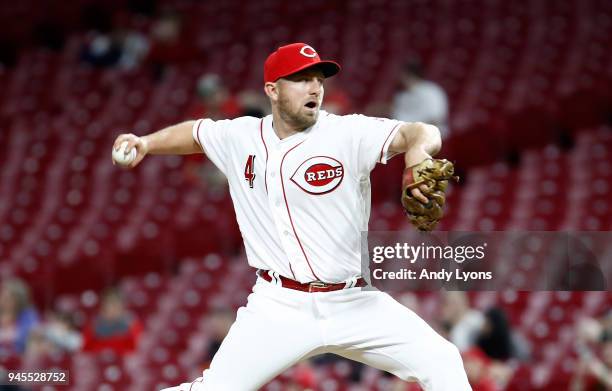 Cliff Pennington of the Cincinnati Reds throws a pitch in the ninth inning against the St. Louis Cardinals at Great American Ball Park on April 12,...