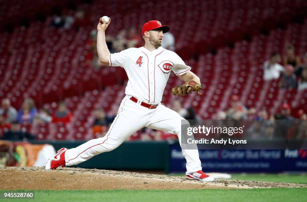 Cliff Pennington of the Cincinnati Reds throws a pitch in the ninth inning against the St. Louis Cardinals at Great American Ball Park on April 12,...