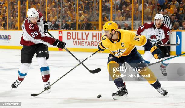 Nathan MacKinnon of the Colorado Avalanche shoots the puck against Roman Josi of the Nashville Predators in Game One of the Western Conference First...