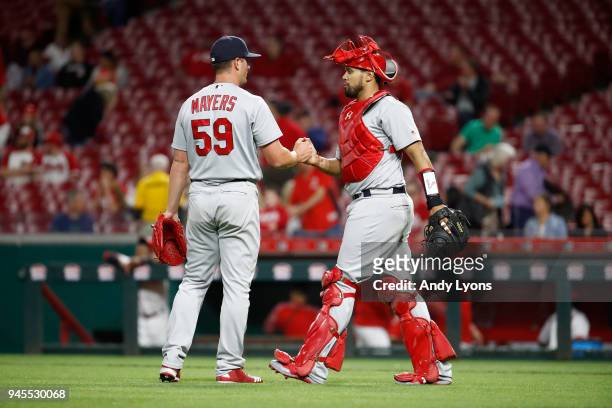 Mike Mayers and Francisco Pena of the St. Louis Cardinals shake hands after the final out of the 13-4 win over the Cincinnati Reds at Great American...