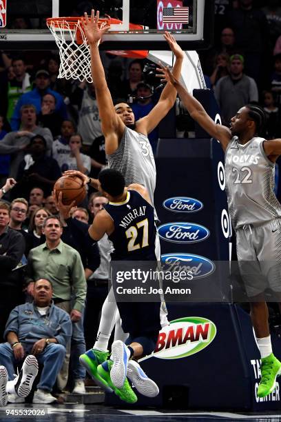 Denver Nuggets guard Jamal Murray loses control of the ball colliding with Minnesota Timberwolves center Karl-Anthony Towns in overtime at the Target...