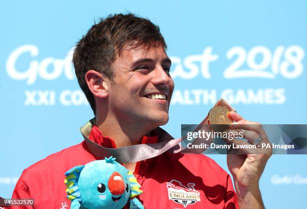 England's Tom Daley with his gold medal in the Men's Synchronised 10m Platform Final at the Optus Aquatic Centre during day nine of the 2018...