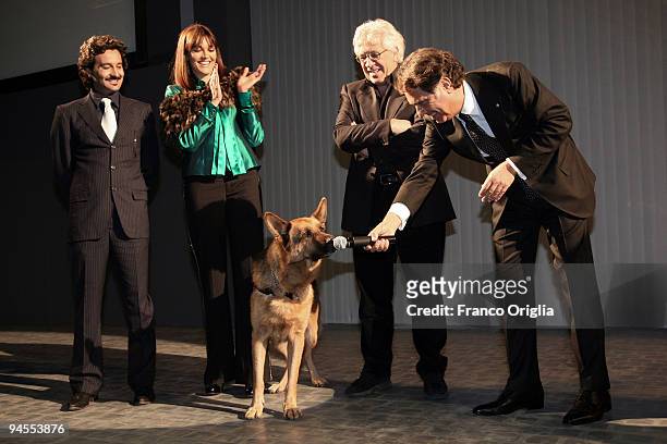 Chief of Italian Police Antonio Manganelli plays with the dog Rex during the 'Belstaff Presents New Uniforms For Italian Police' at the Direzione...