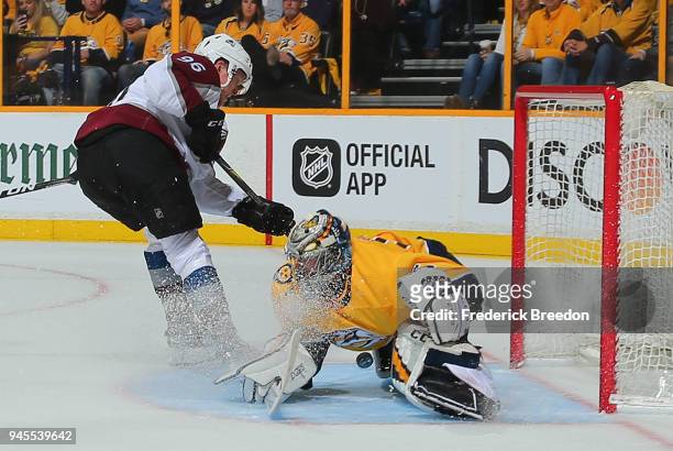 Goalie Pekka Rinne of the Nashville Predators makes a save on a breakaway shot by Mikko Rantanen of the Colorado Avalanche during the second period...