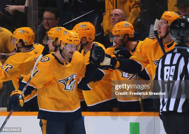 Austin Watson of the Nashville Predators is congratulated by teammates after scoring a goal against the Colorado Avalanche during the second period...