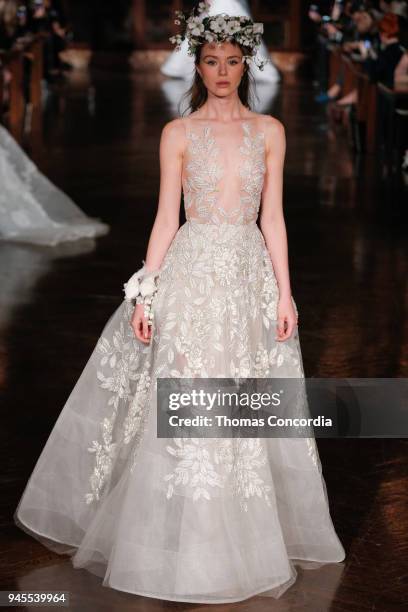 Model walks the runway wearing Reem Acra Spring 2019 Bridal Collection with hair by Brian Buenaventura and makeup by Cassandra Garcia at the New York...