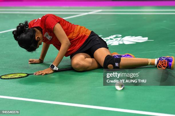 India's Ruthvika Gadde sits on the floor after sustaining an injury against Scotland's Kirsty Gilmour during their badminton women's singles...