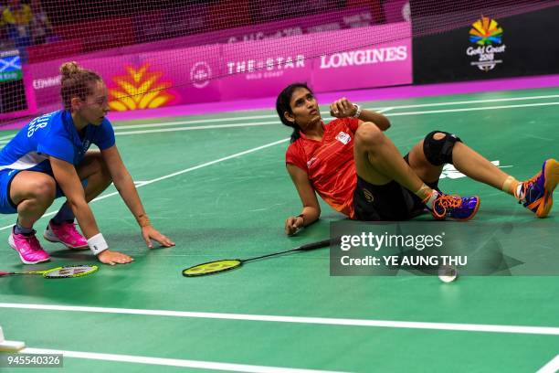 India's Ruthvika Gadde sits on the floor after sustaining an injury against Scotland's Kirsty Gilmour during their badminton women's singles...