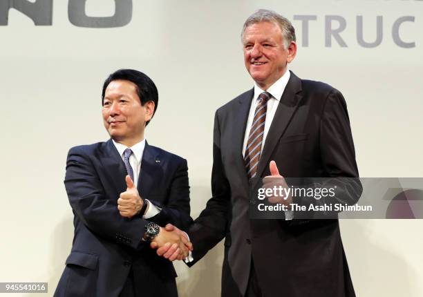 Hino Motors President Yoshio Shimo and Volkswagen Truck & Bus CEO Andreas Renschler shake hands during a joint press conference on their partnership...