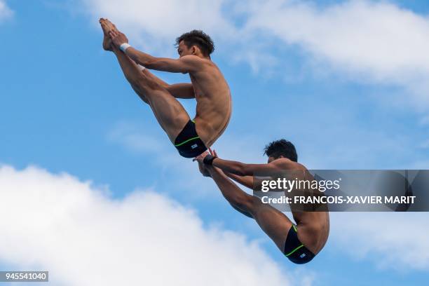 Malaysia's Jellson Jabillin and Hanis Nazirul Jaya Surya compete in the men's synchronised 10m platform diving in the 2018 Gold Coast Commonwealth...