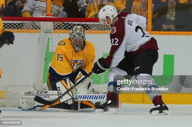 Goalie Pekka Rinne of the Nashville Predators makes a save on Colin Wilson of the Colorado Avalanche during the third period of a 5-2 Predators...