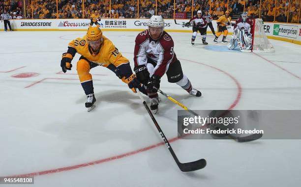 Colton Sissons of the Nashville Predators and David Warsofsky of the Colorado Avalanche fight for a puck during the third period of a 5-2 Predators...