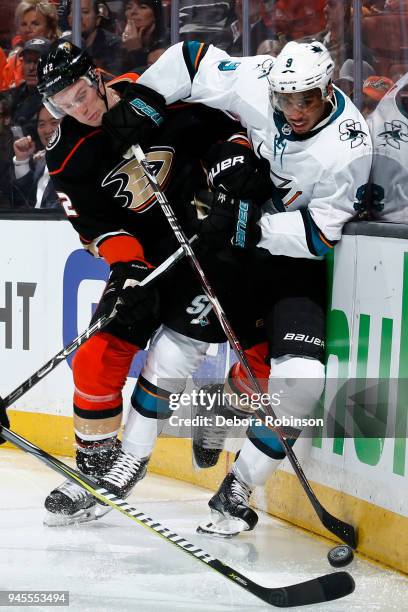 Josh Manson of the Anaheim Ducks battles for the puck against Evander Kane of the San Jose Sharks in Game One of the Western Conference First Round...