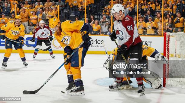 Ryan Ellis of the Nashville Predators blocks a shot in front of Pekka Rinne as Mikko Rantanen of the Colorado Avalanche battles in front of the net...