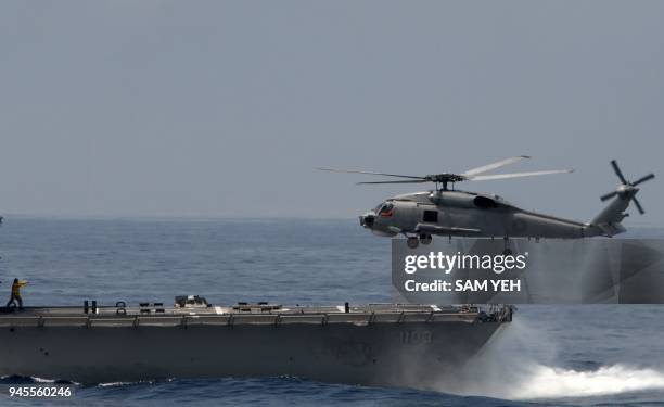 Made S70C helicopter is guided by a navy soldier during take off from a frigate at the sea near the Suao navy harbour in Yilan, eastern Taiwan, on...