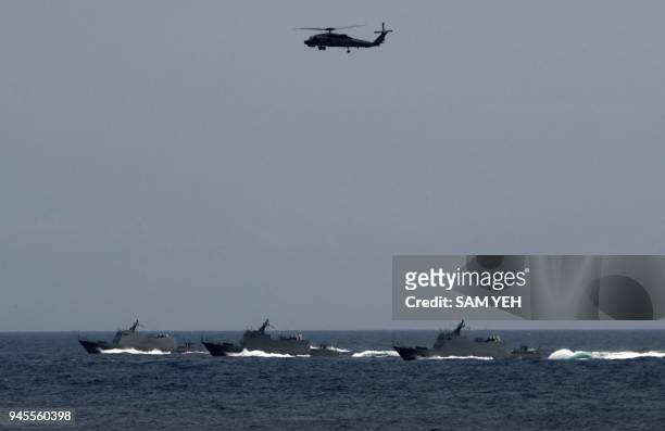 Three local made missile boats and a US-made S70C helicopter take part in a drill at the sea near the Suao navy harbour in Yilan, eastern Taiwan, on...