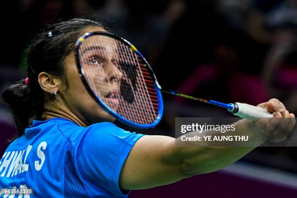 India's Saina Nehwal hits a return against Canada's Rachel Honderich during their badminton women's singles quarter-final match at the 2018 Gold...