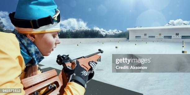 athletic woman at the biathlon competitions. athlete recharges the gun - biathlon ukraine stock pictures, royalty-free photos & images