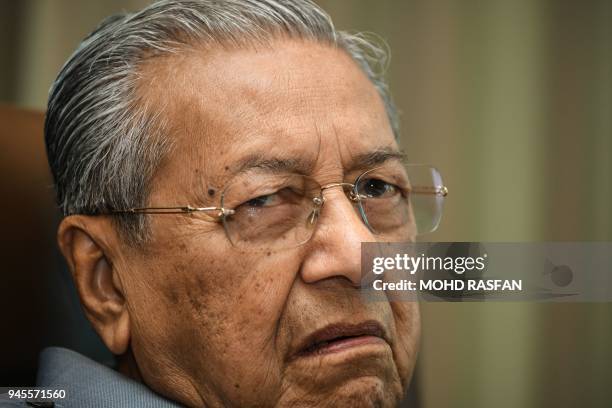 Former Malaysia's prime minister Mahathir Mohamad listens to questions during an interview with Agence France Presse at his office in Kuala Lumpur on...