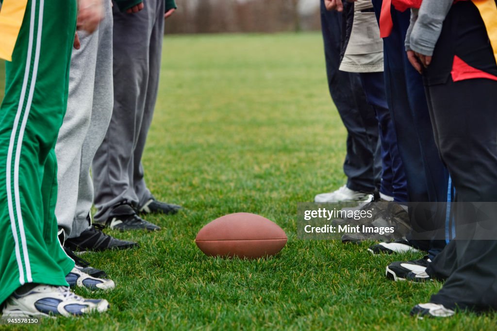 Close up of a friends getting ready for an American Flag Football game.