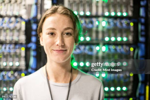 caucasian woman technician in a large computer server farm. - semiconductor stockfoto's en -beelden