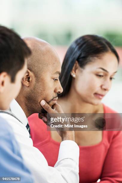 mixed race team of business people at a table in a business centre. - conference 2012 day 3 stockfoto's en -beelden