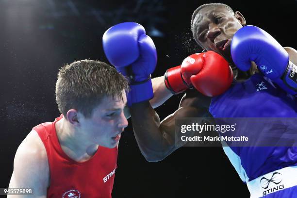 Thomas Blumenfeld of Canada and Jessie Lartey of Ghana compete in their Men's Light Welter 64kg Semifinal bout during Boxing on day nine of the Gold...